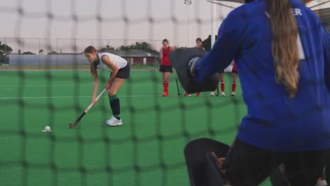 Female-hockey-players-playing-on-the-field