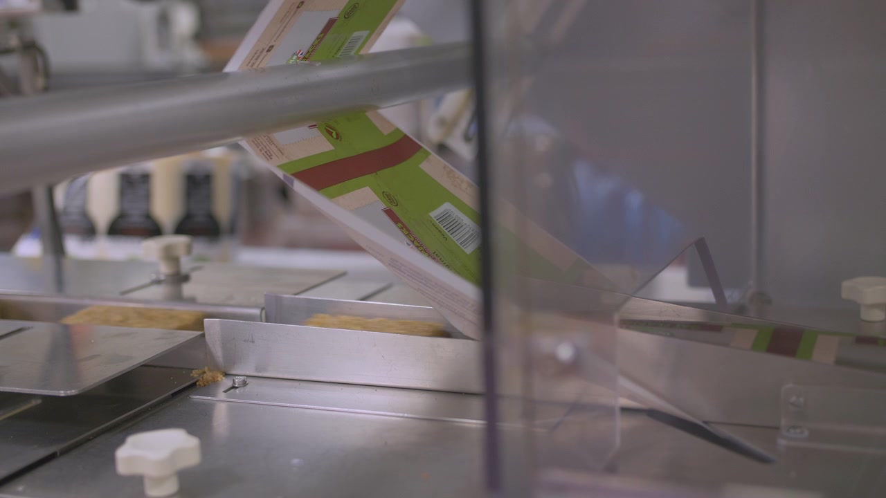 Close up of an automated process for packaging cake bars. Laser technology guides precision