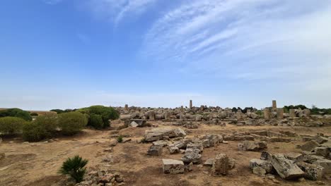 Pan-left-at-ruins-of-Greek-temples-and-columns-at-Selinunte-archaeological-park-in-Sicily,-Italy