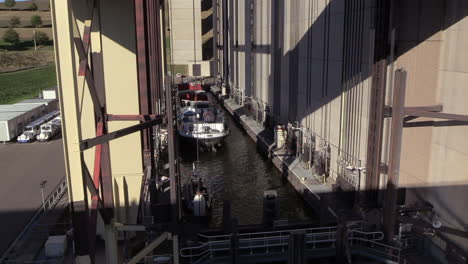 sluice lock closing the water container with a small boat and cargo ship inside at the strépy-thieu boat lift