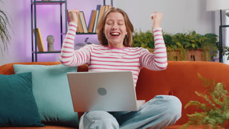 amazed young woman use laptop computer, receive good news message, shocked by victory, celebrate win