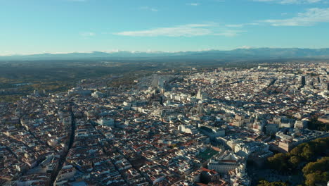 Aerial-panoramic-footage-of-large-city-at-golden-hour.-Light-building-facades-reflecting-bright-sunshine.