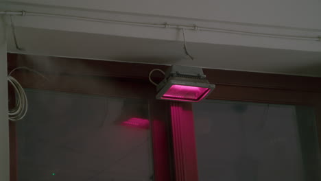 pink floodlight on building exterior at night