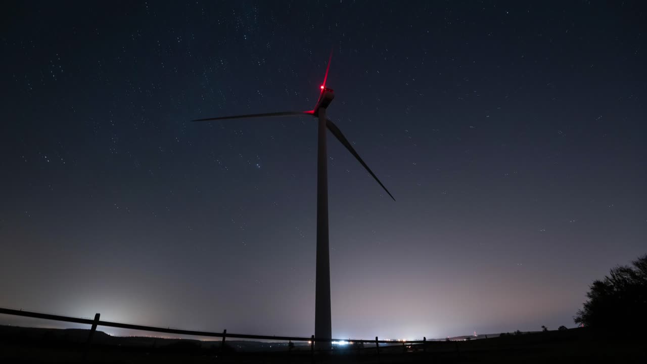 Wind Turbine at Night Under a Starry Sky