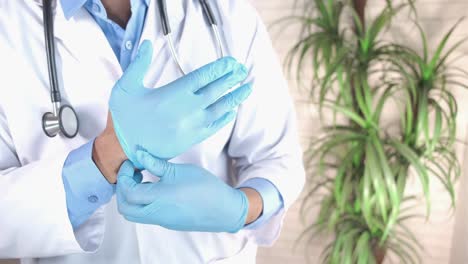 doctor putting on medical gloves