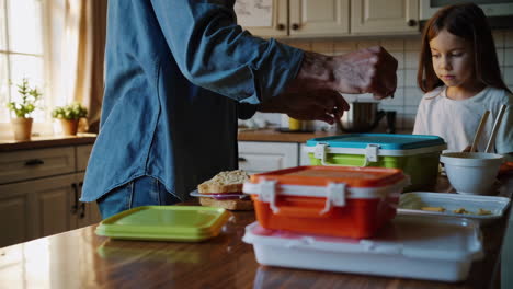 father and daughter packing lunch