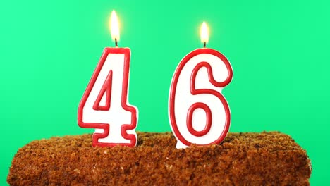 cake with the number 46 lighted candle. chroma key. green screen. isolated