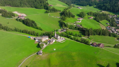 drone view of the picturesque st. magdalena church nestled in the lush green valley of val di funes