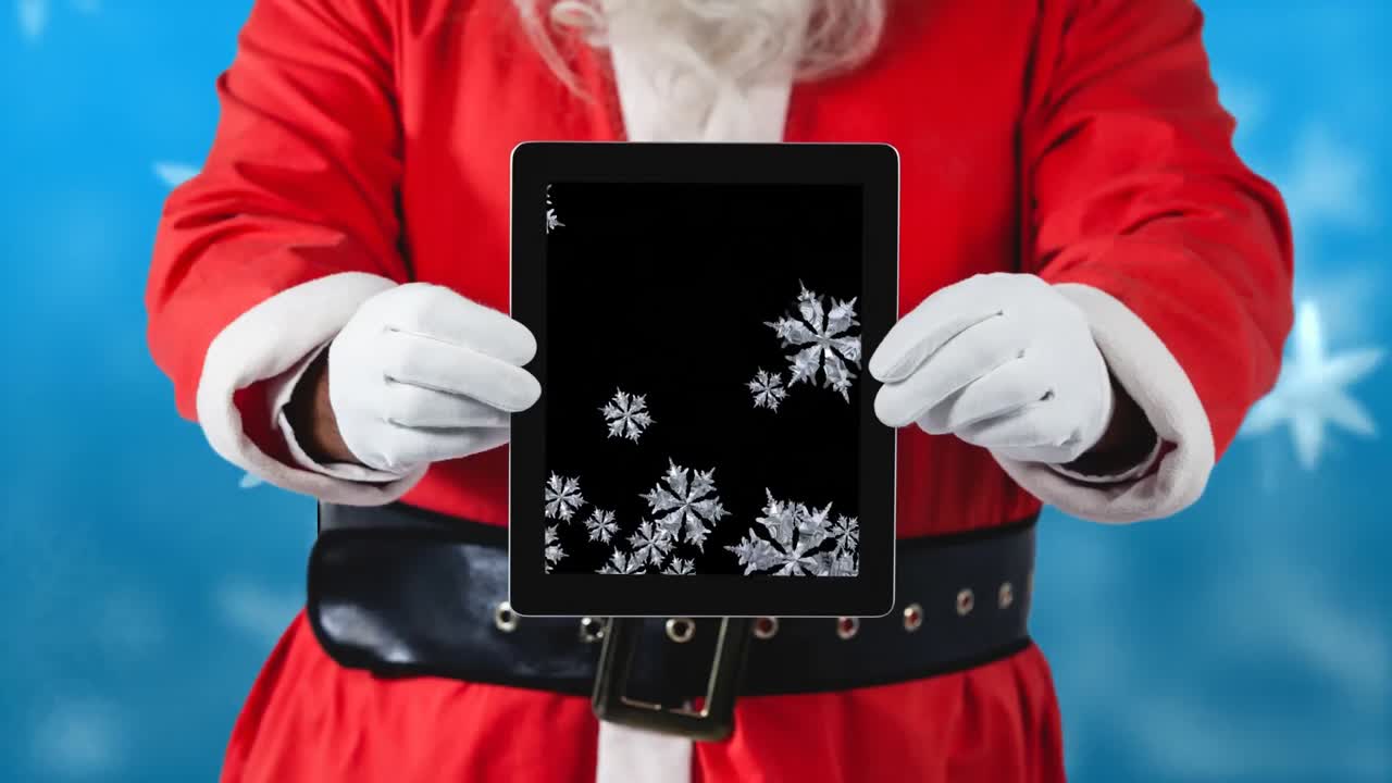 스노우플레이크를 가진 태블릿을 사용하는 산타
