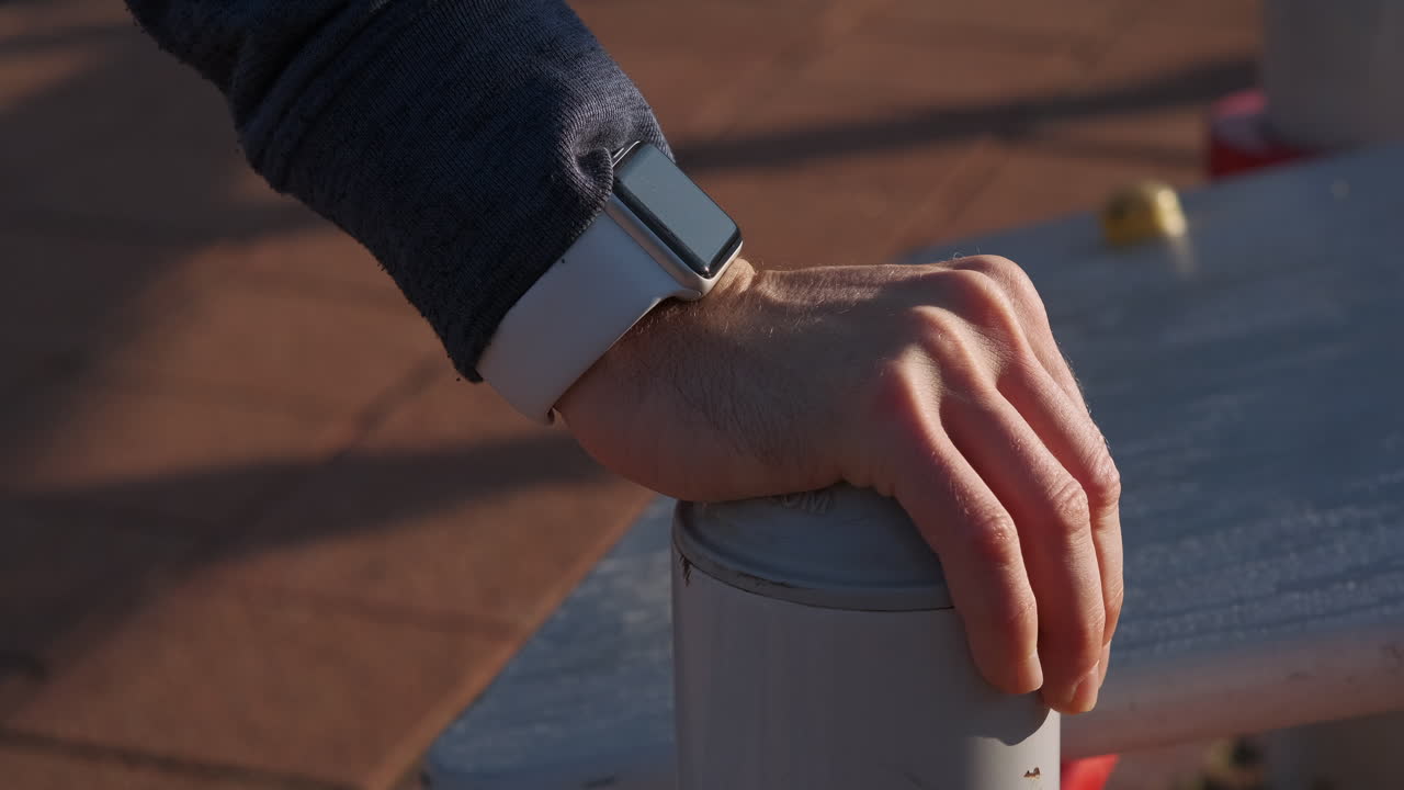 Man exercising outdoors with smartwatch