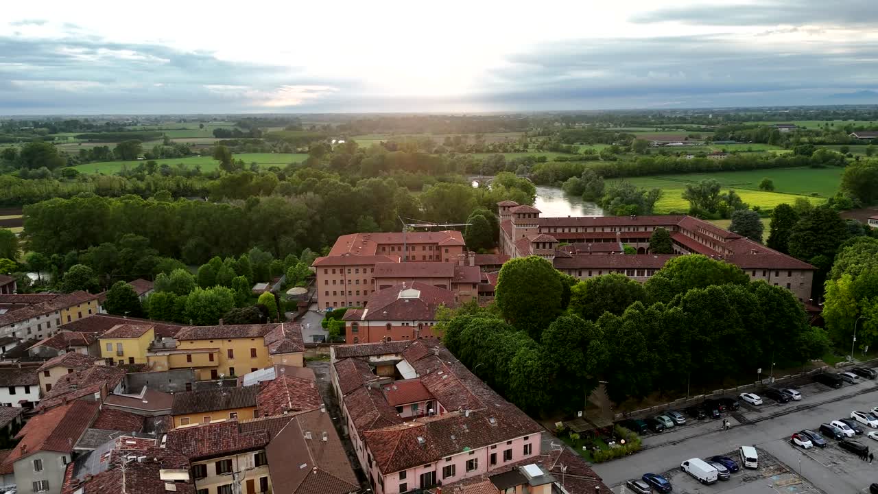 Aerial view of Castello di Pontevico, a medieval fortification now used as a neuropsychiatric institute, with the Oglio River and Lombardy countryside in the background