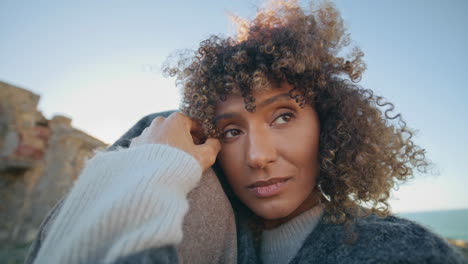closeup couple embracing sea beach. curly romantic woman cuddling unknown man