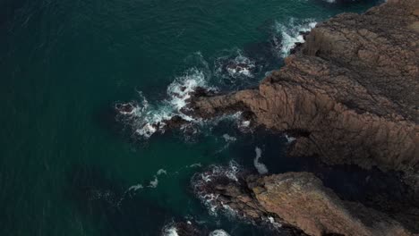 Aerial-drone-above-blue-rock-peninsular-beach-at-Kyotango-Kyoto-Japan-sea-travel,-white-sand-pristine-coastline-panoramic-top-view-landscape