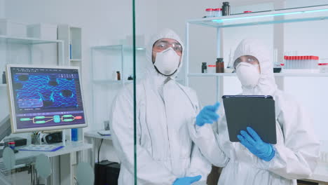 team of scientists in ppe suit using virtual reality in chemistry lab