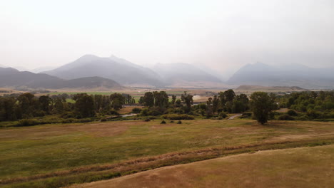 mountain valley landscape with foggy sky