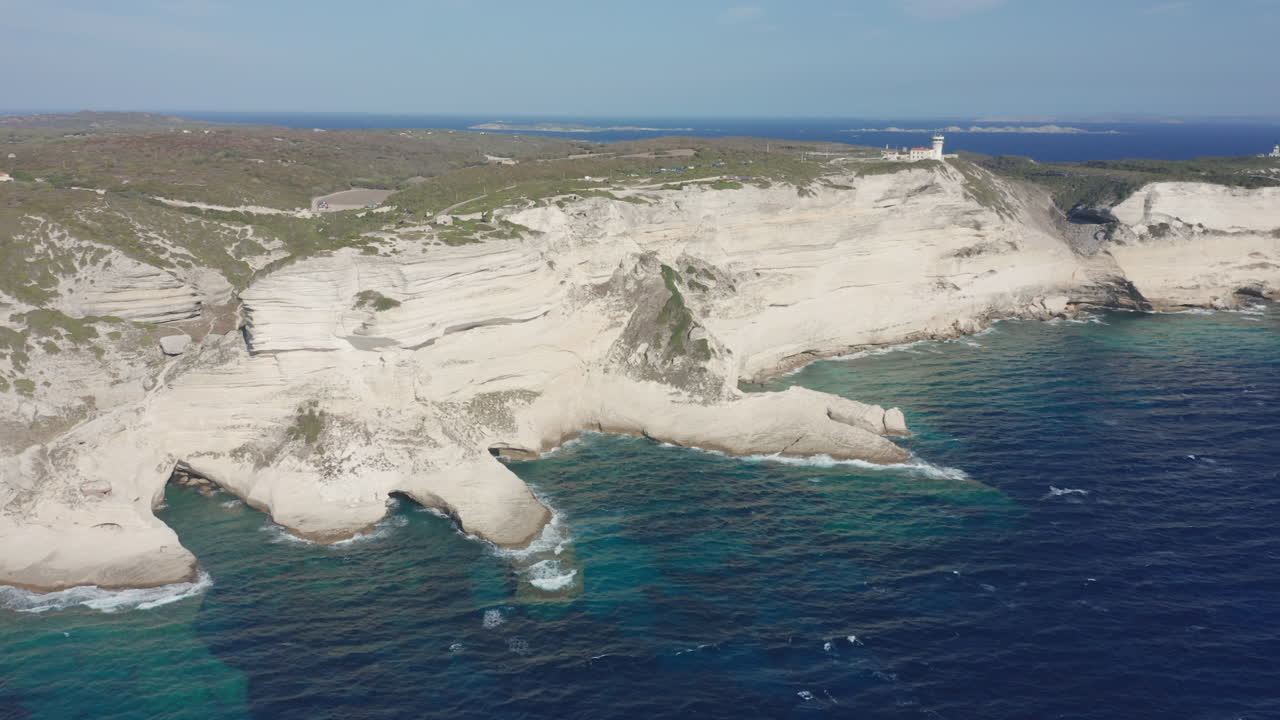 Bonifacio Corsica aerial drone shot coastline cliffs lighthouse rugged limestone landscape the turquoise Mediterranean Sea iconic French island