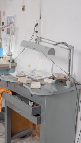 a detailed view of a craftsman's workbench with tools and materials