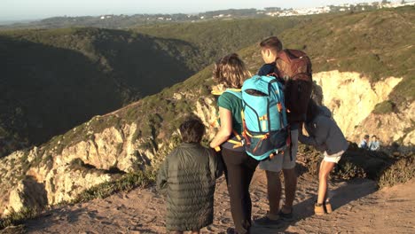 Family-couple-with-camping-backpacks-and-kids