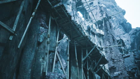 ruins of an ancient structure with wooden scaffolding in a rocky landscape