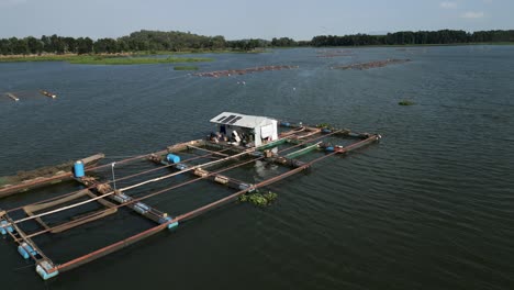 fish farm on a lake with floating cages