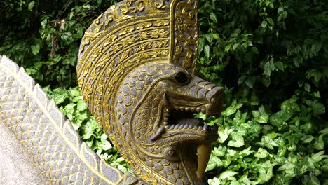 Ornate-golden-serpent---dragon-staircase-entrance-to-Wat-Tham-Chiang-Dao,-mountain-temple-in-rain-forest