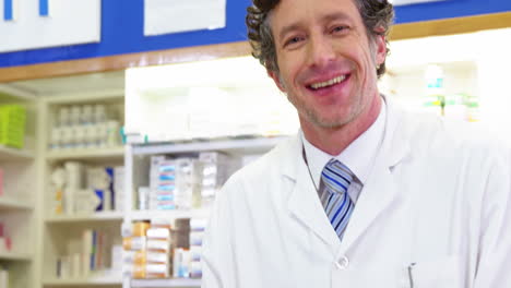 pharmacist giving pill bottle to customer