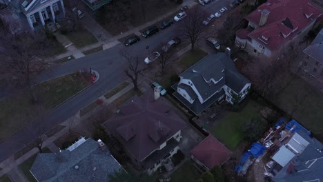 drone flies over brooklyn new york city from one neighborhood of detached mansions across the tracks to apartments and housing projects