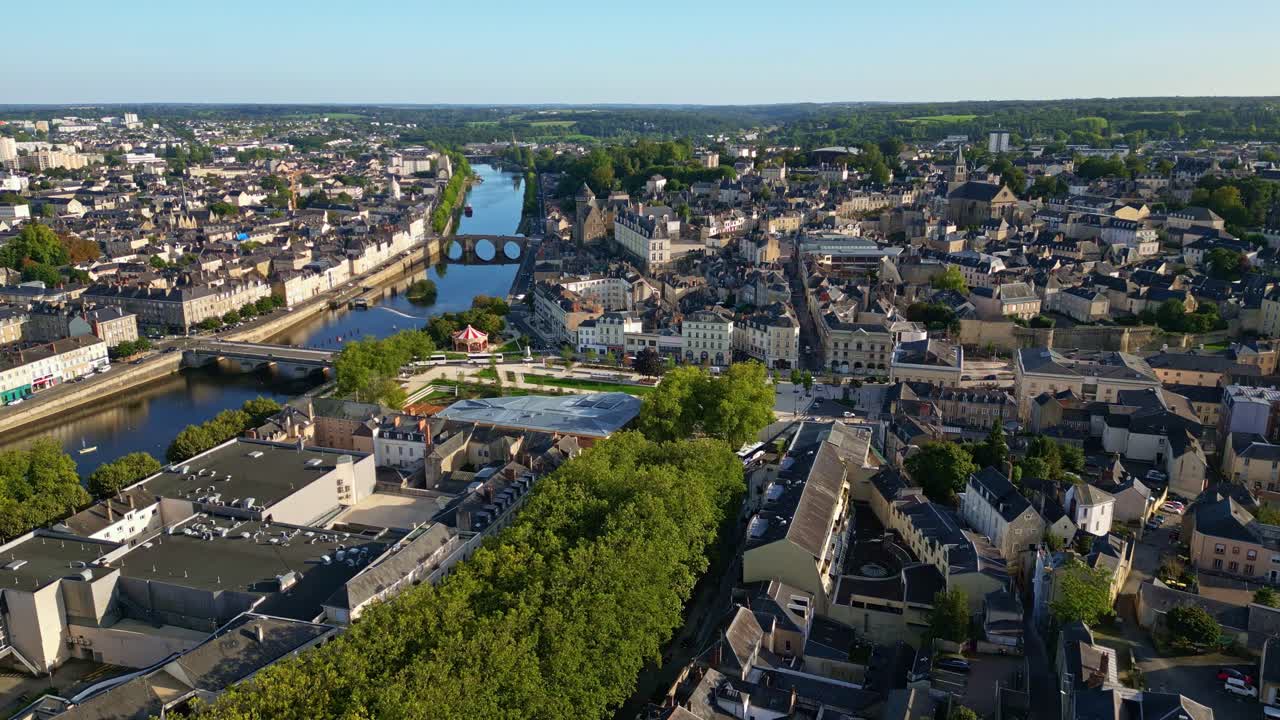 Drone moves backward and descends over Laval city showing bridges, castle, and Mayenne River