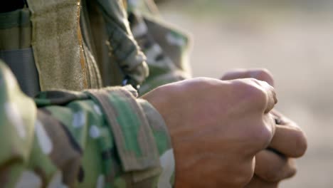 Mid-section-of-military-soldier-holding-rifle-magazine-during-training-4k