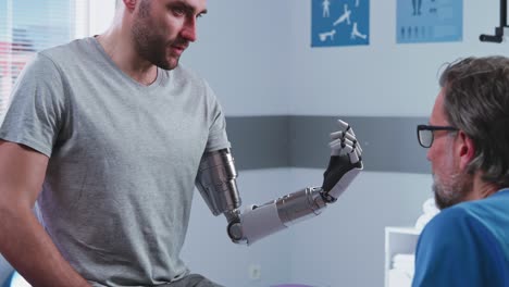 happy patient learning to use bionic arm near doctor