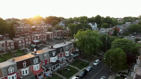 aerial establishing shot of early 1900s homes in united states city, urban low income housing projects during sunrise