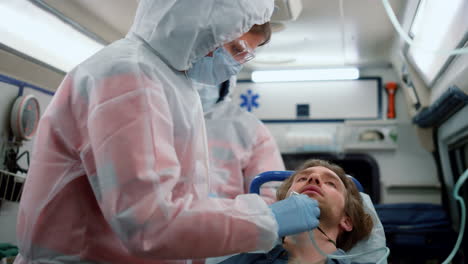 emergency medical doctors giving first aid help to patient