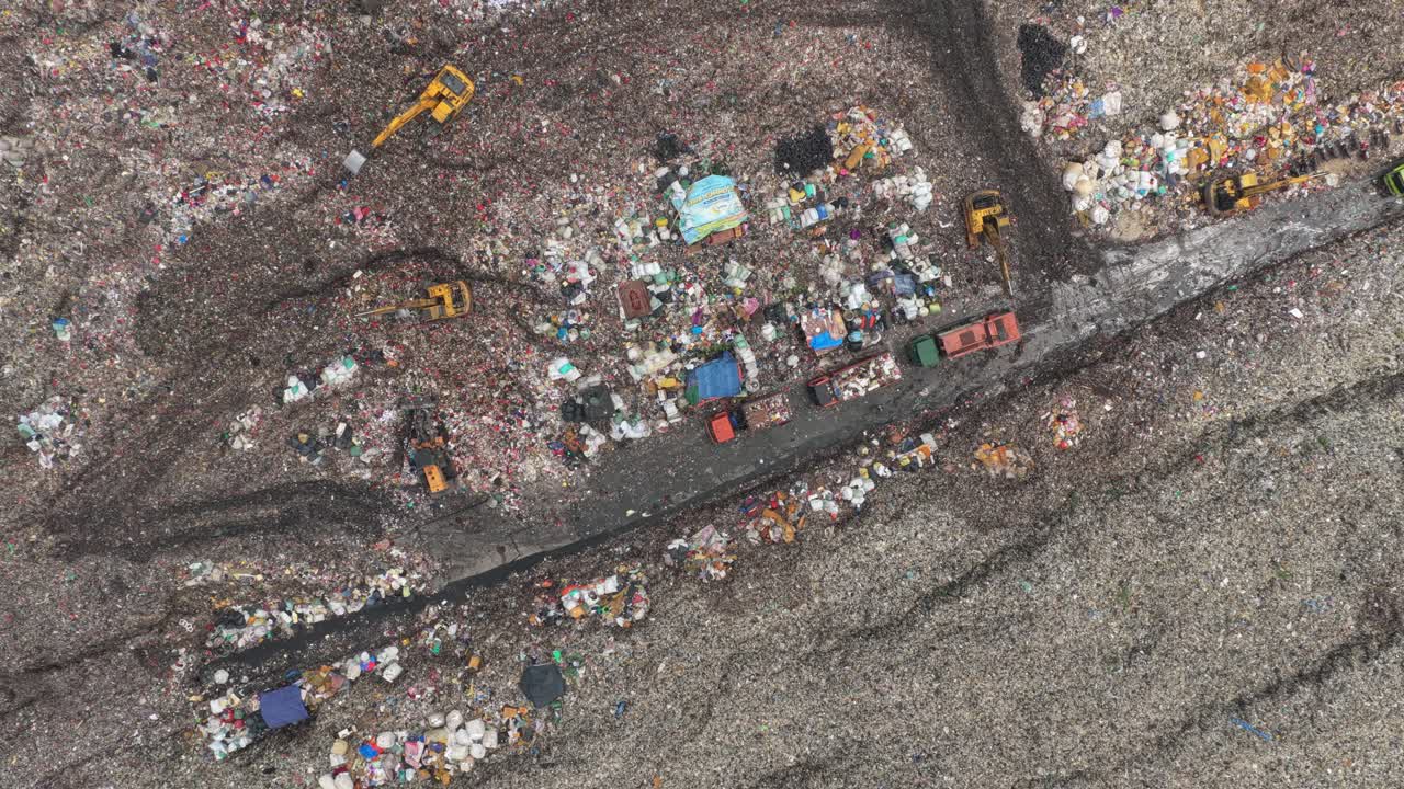 Aerial view of trucks and excavators at bantar gebang landfill