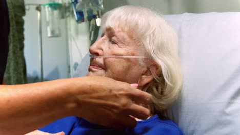 nurse examining a senior patient in the ward 4k