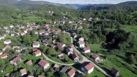 aerial of a small typical village with mosque in the bosnian mountains