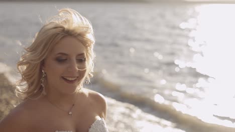 beautiful and lovely bride walking along the coast of the sea