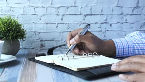 person writing in a planner