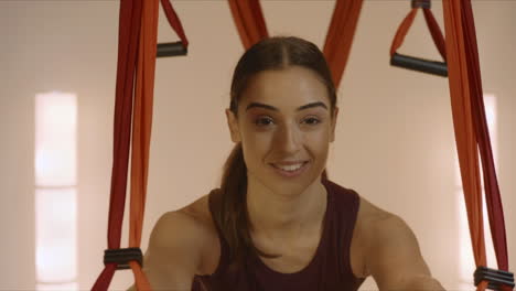 gymnast stretching body with yoga straps. woman doing yoga in fitness class