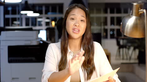 biracial woman discusses documents at a business office