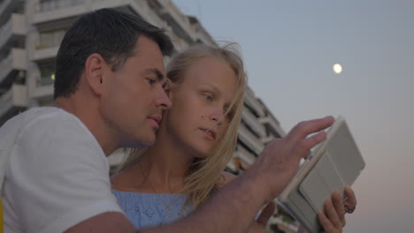 Couple-with-pad-on-sea-front-in-the-evening