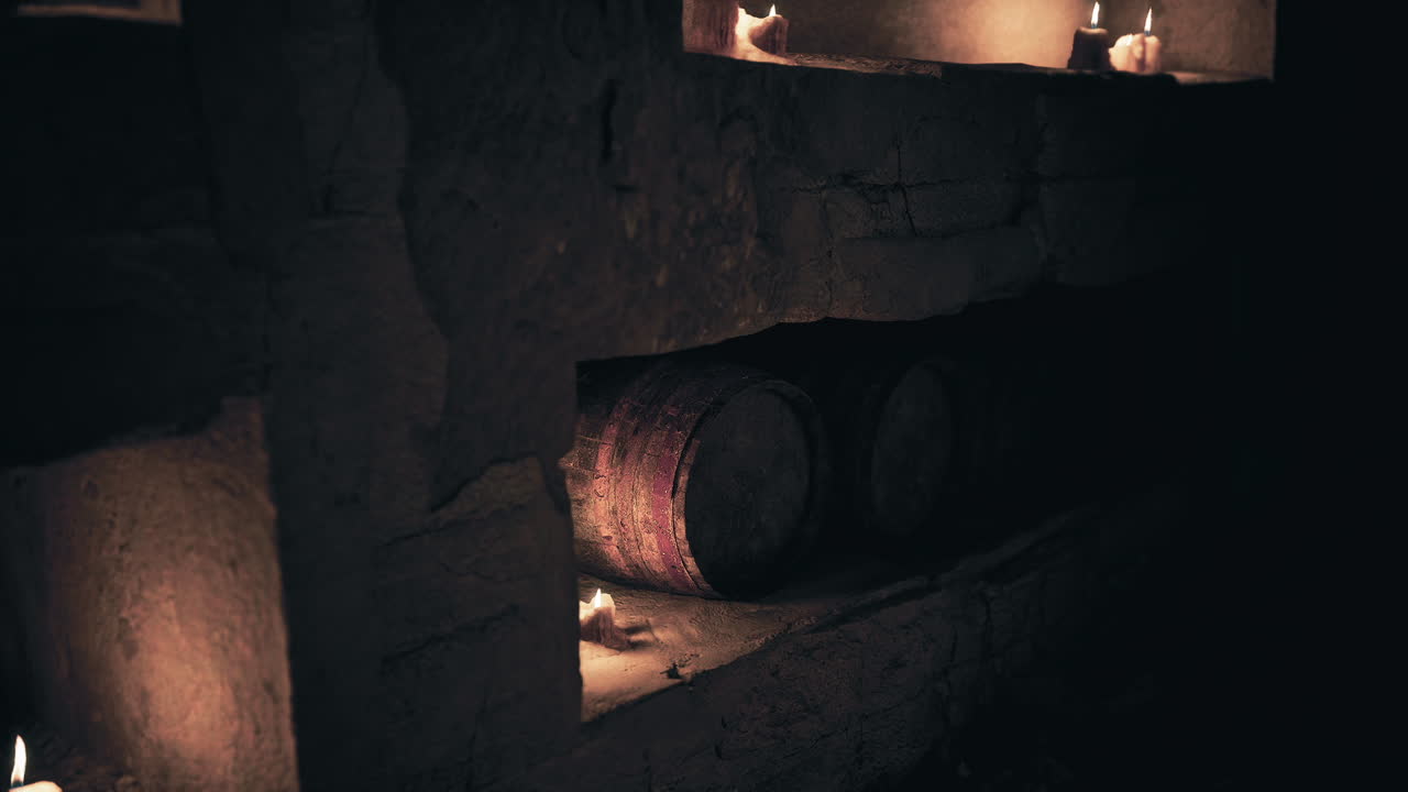 Candlelight illuminating wooden barrels in a dim cellar