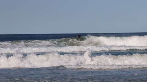 sequence of a surfer catching and riding a wave