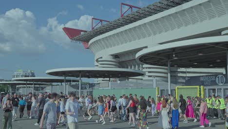 large crowd gathered outside a stadium entrance