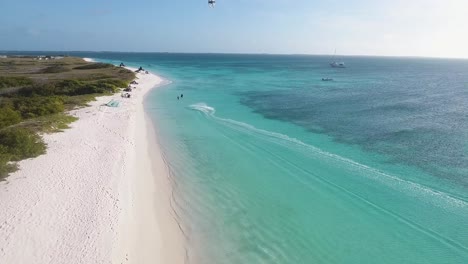 man acrobatic jumps and kitesurfing tricks caribbean sea, drone shot los roques