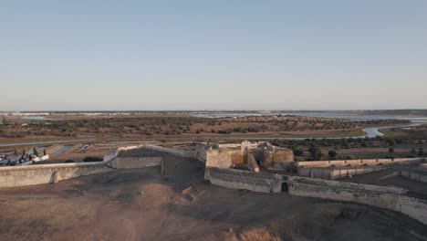 drone flying around a medieval castle in portugal, famous and recognized for its antiquity and architecture, great color in daylight