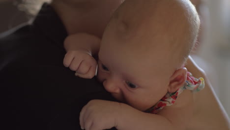 Two-months-baby-girl-on-mothers-shoulder