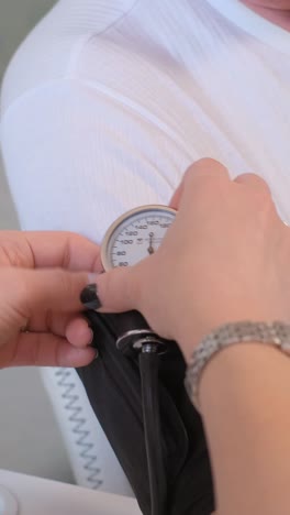 family doctor measuring the blood pressure of an elderly man.