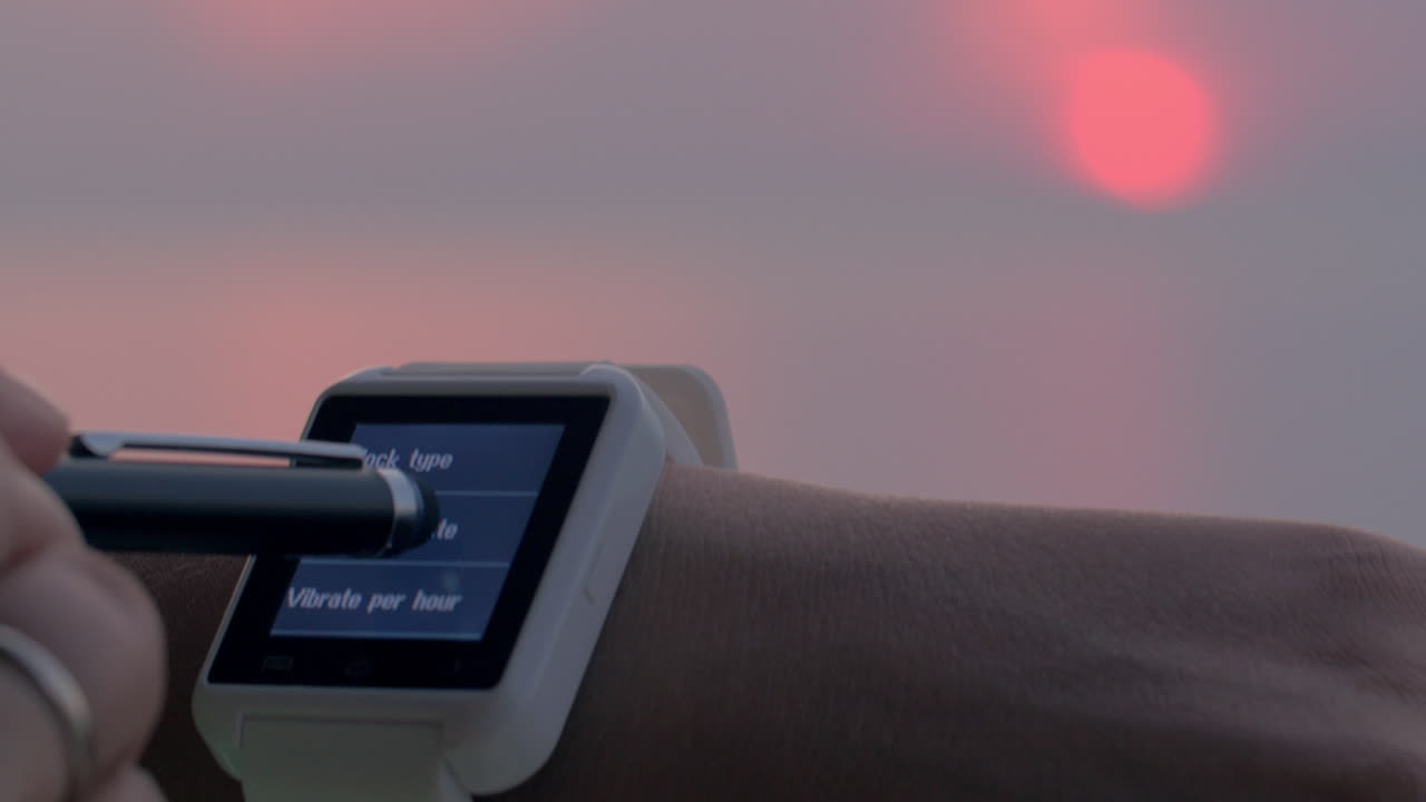 Woman setting home city on smartwatch