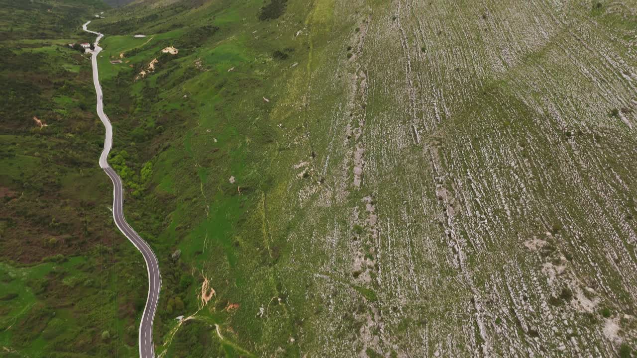 Albanian mountain aerial view with winding road in peaceful landscape