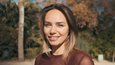 close-up view of woman looking at camera outdoor.